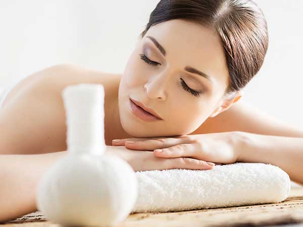 Woman using aromatherapy for stress at spa.