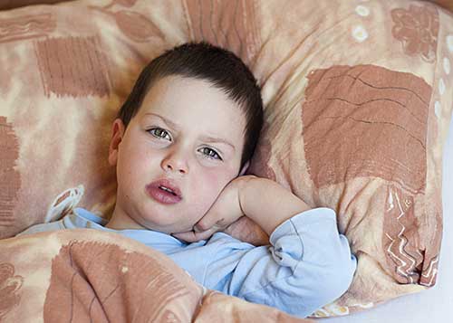 Young boy in bed