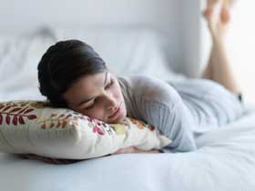 lady laying on mattress