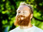 Man with red beard getting sunshine outdoors.
