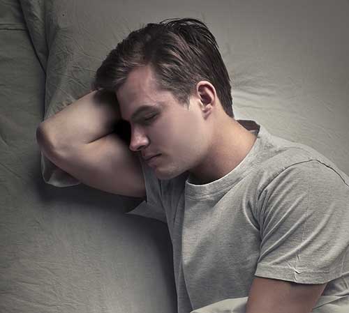 Young man in t-shirt sleeping