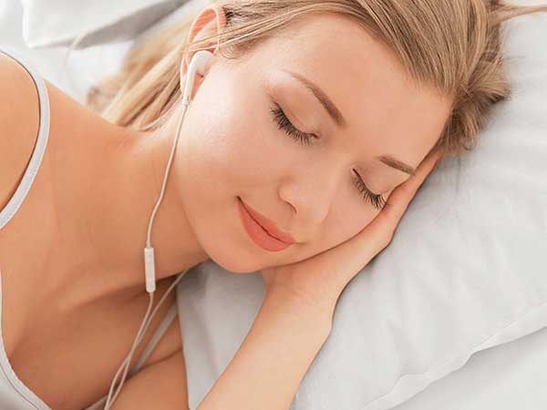Woman listening to music while falling asleep.