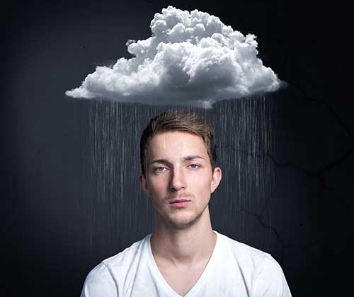 Irritated, depressed man under rain cloud suffering from side effects of insomnia