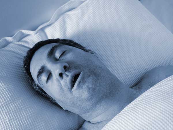 Man with sleep apnea and diabetes laying on back snoring.