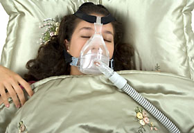 Woman sleeping with Cpap mask on.