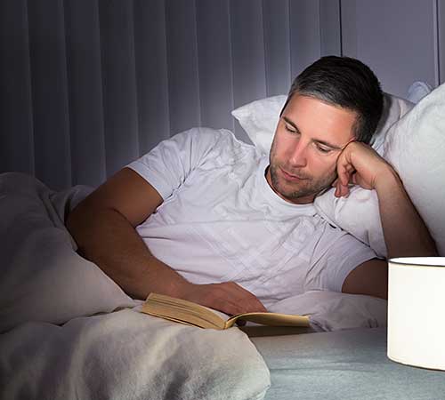 Man reading before bed