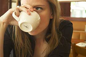 Woman drinking cup of coffee.